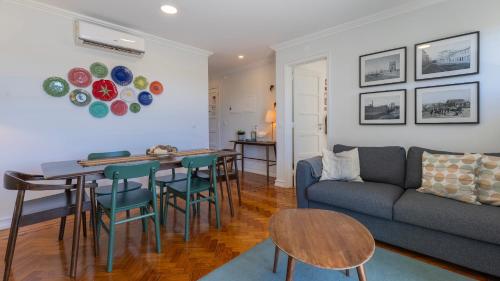 a living room with a couch and a table at Charming Belém 3BDR Property by LovelyStay in Lisbon