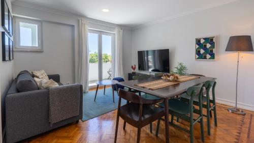 a living room with a table and a couch at Charming Belém 3BDR Property by LovelyStay in Lisbon
