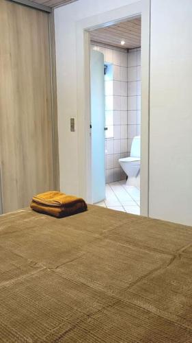 a bed with a brown pillow on top of it in a bathroom at Billund Centre Rica House,500m to Lego House in Billund