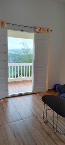 a room with a sliding door with a view of a balcony at Laural Meadows in Vagamon