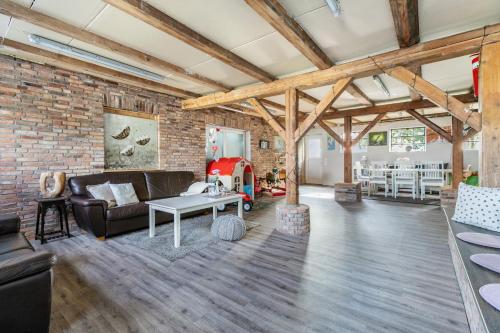 an open living room with a brick wall at Ferienwohnung Hof Krakebüll in Humptrup