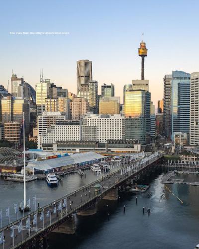 a bridge over a river with a city in the background at Chic Darling Harbour Oasis in the Heart of Sydney, 2BR 2BA, Resort-Style Amenities in Sydney