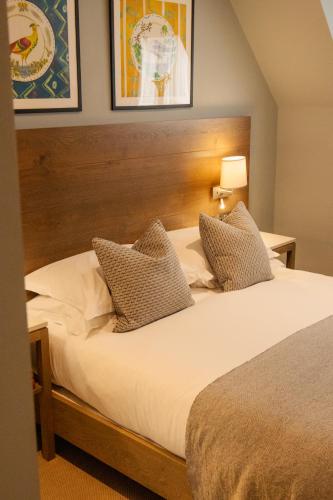 a bedroom with a large bed with white sheets and pillows at The Georgian, Haslemere, Surrey in Haslemere