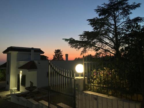 a fence with a light on top of a house at Villa Paci sulle colline salentine in Parabita