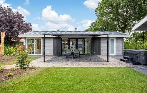 an open patio with a table and a grill at Luxurious Home In Voorthuizen With Wifi in Voorthuizen