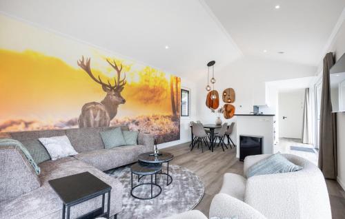 a living room with a couch and a painting of a deer at Luxurious Home In Voorthuizen With Wifi in Voorthuizen