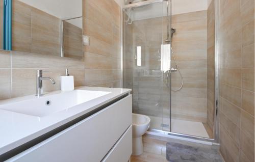 a bathroom with a sink and a shower and a toilet at 2 Bedroom Nice Apartment In Gonnesa in Gonnesa