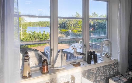 a window sill with a sink and a view of the water at Nice Home In Figeholm in Figeholm