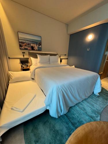 a large white bed in a hotel room at Novotel Recife Marina in Recife