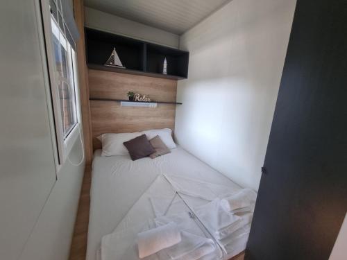 a small bedroom with a bed in a room at Mobile Home Elica, Pirovac in Pirovac