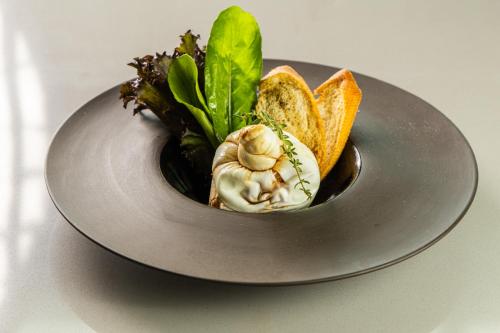 a plate of food with bread and vegetables on it at Novotel Recife Marina in Recife