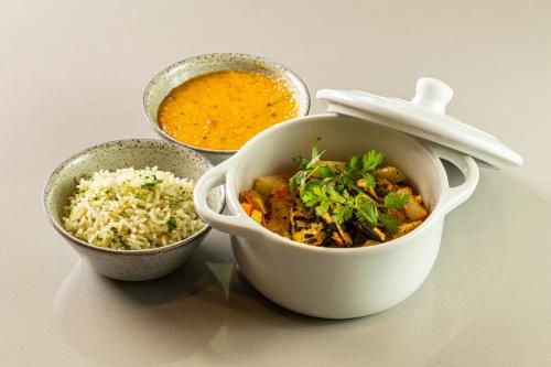 two bowls of food and a bowl of rice at Novotel Recife Marina in Recife