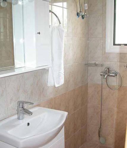 a bathroom with a sink and a shower at Lihas Studios in Agios Georgios