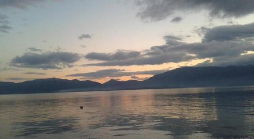 a sunset over a large body of water at Lihas Studios in Agios Georgios