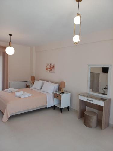 a bedroom with a bed and a desk and a mirror at Agrilia in Lefkada