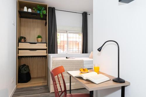 a small apartment with a desk and a bed and a bedroom at SingularStays Padre Urbano in Valencia