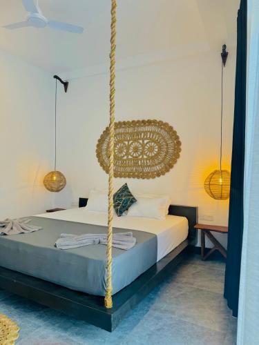 a bedroom with two beds and a hanging bed at The Jini House in Ahangama