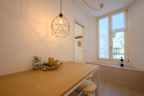 a dining room with a table and a window at Appartamento Garibaldi in Morbegno