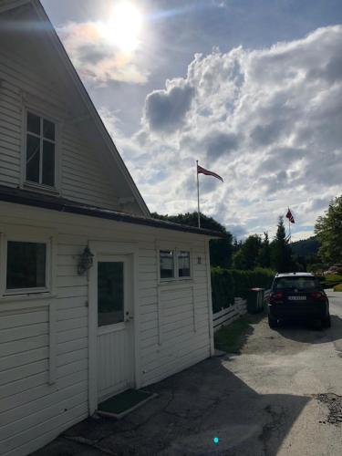 a car parked in a parking lot next to a house at Flat in the center of Loen in Loen