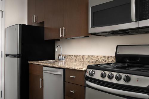 a kitchen with a stove and a microwave at TownePlace Suites by Marriott Goldsboro in Goldsboro
