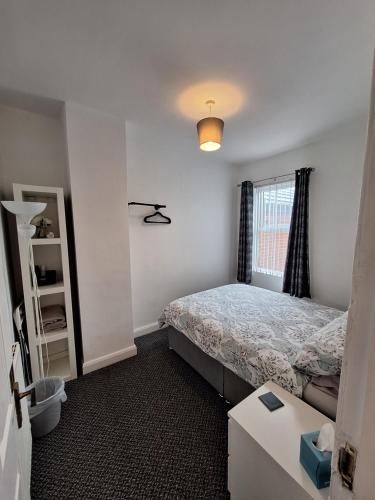 a small bedroom with a bed and a window at Private Room on Donegall Road in Central Belfast in Belfast