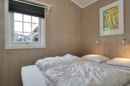a bedroom with two beds and a window at Bitigrenda L in Beitostøl