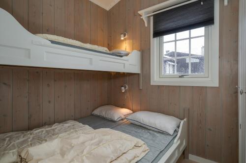 a bedroom with a bunk bed and a window at Bitigrenda L in Beitostøl