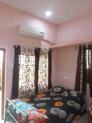 a bedroom with a bunk bed with a black and white comforter at Swami's Yatri nivas in Akalkot