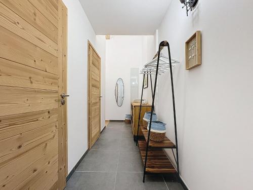 un couloir avec une porte en bois et un escalier dans l'établissement Les 3 Mousquetons-appartement-6-8 Pers-Proche centre, aux Gets