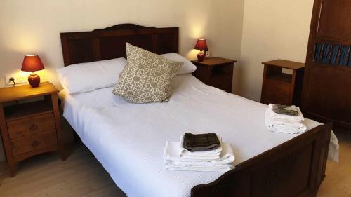 a bedroom with a large bed with towels on it at 18 on the Rue in Eymet