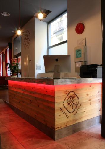 a wooden counter with a laptop on top of it at Ok Hostel Madrid in Madrid