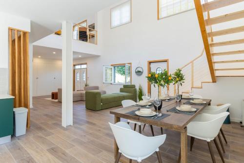 a dining room and living room with a table and chairs at Quinta do Fontanário by LovelyStay in Celorico de Basto