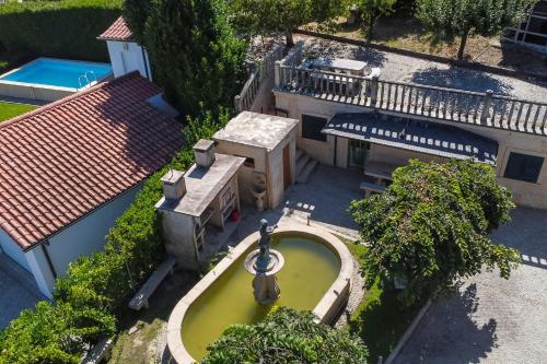 an aerial view of a house with a fountain at Quinta do Fontanário by LovelyStay in Celorico de Basto