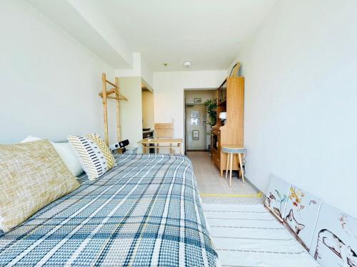a bedroom with a bed with a plaid blanket at Alo BnB 14 - Cats and Coffee - Near Shibuya ! Self check-in in Tokyo