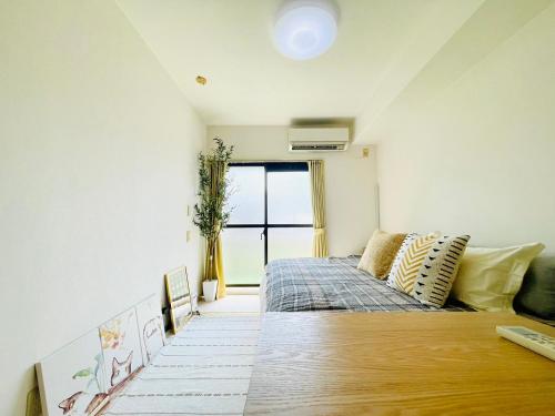a small bedroom with a bed and a window at Alo BnB 14 - Cats and Coffee - Near Shibuya ! Self check-in in Tokyo