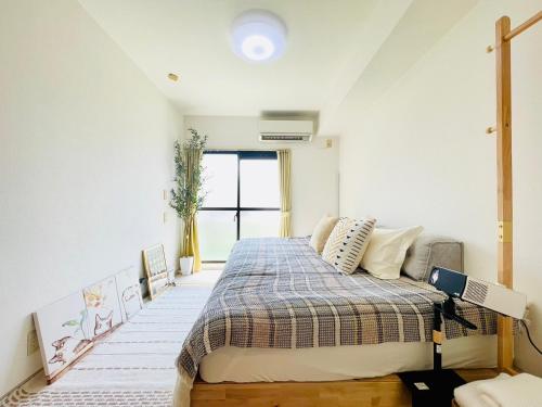 a bedroom with a bed and a window at Alo BnB 14 - Cats and Coffee - Near Shibuya ! Self check-in in Tokyo