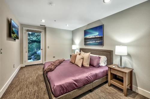 a bedroom with a bed with purple sheets and a window at Luxe11 blue diamond VIP mega lodge lake tahoe in Stateline