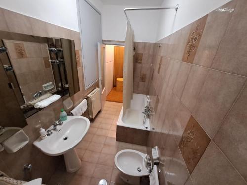 a bathroom with a sink and a shower and a toilet at Trevi al Centro in Trevi