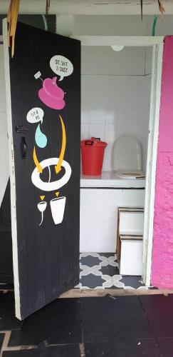 a door in a kitchen with some drawings on it at Casa en el agua in Tintipan Island