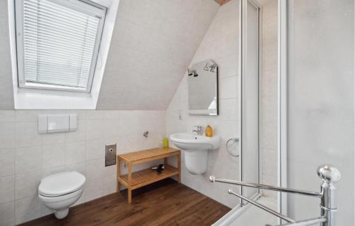 a bathroom with a toilet and a sink at Cozy Home In Bad Brambach With Sauna in Bad Brambach