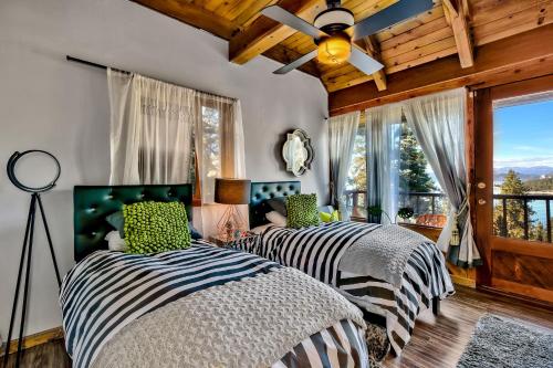 two beds in a room with a window at LX07 Skyfall lakeview house with dry sauna close to Edgewood in Zephyr Cove