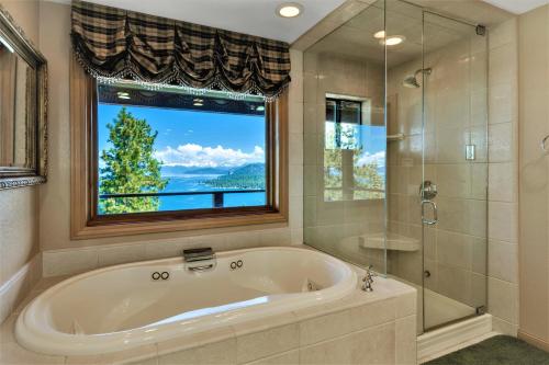 a large bathroom with a tub and a window at Lx10 lakeview jewel of sierra theater , hot tub in Zephyr Cove