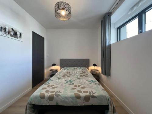 une chambre avec un lit et deux lampes et une fenêtre dans l'établissement Ty-Kern, à Riantec