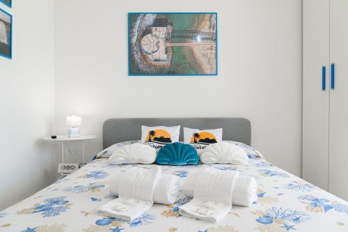 a bedroom with a bed with towels on it at B&B VistaMare in Civitavecchia