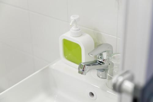 a bathroom sink with a soap dispenser on it at B&B VistaMare in Civitavecchia