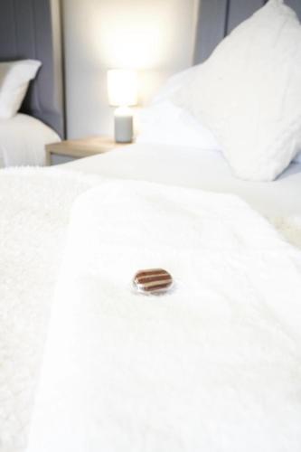 a close up of a white bed with a button on it at Barclay House in Livingston