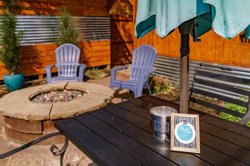 a table with an umbrella and two chairs and a fire pit at #StayInMyDistrict Hyde Park Studio Up in Boise
