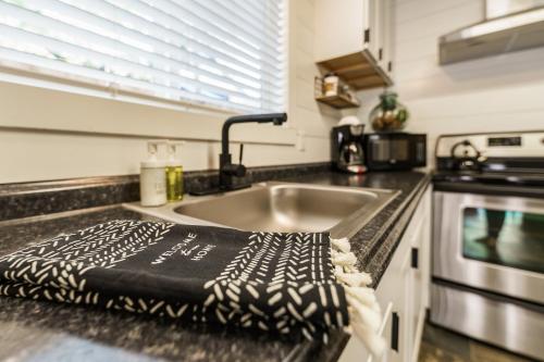 a kitchen counter with a sink and a towel on it at #StayInMyDistrict Hyde Park Bungalow in Boise