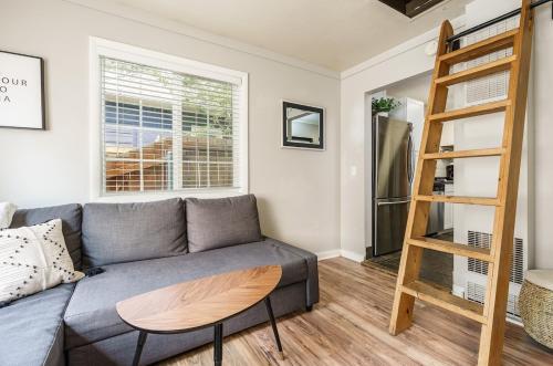 a living room with a couch and a ladder at #StayInMyDistrict Hyde Park Bungalow in Boise