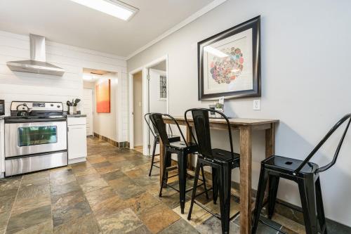 a kitchen with a table and chairs in a room at #StayInMyDistrict Hyde Park Bungalow in Boise